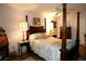 Spacious bedroom with a large wooden bed frame and two lamps at 6472 Seagull Dr # 303, Bradenton, FL 34210