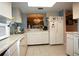 Kitchen with view to dining area, white cabinets, and appliances at 6472 Seagull Dr # 303, Bradenton, FL 34210