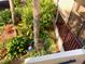 Lushly landscaped patio with tropical plants and red mulch at 6472 Seagull Dr # 303, Bradenton, FL 34210