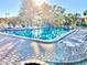 Community pool with lounge chairs and a fire pit at 6472 Seagull Dr # 303, Bradenton, FL 34210