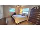 Bright bedroom with double bed, dresser, and window coverings at 6773 14Th N Ave, St Petersburg, FL 33710