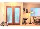 Entryway with double doors, hardwood floors, and vintage furniture at 6773 14Th N Ave, St Petersburg, FL 33710