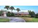 Brick home with palm trees, driveway, and landscaped yard at 6773 14Th N Ave, St Petersburg, FL 33710