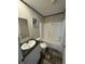 Clean bathroom with shower/tub combo and wood-look floor at 7337 Desant Ln, Port Charlotte, FL 33981