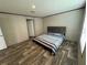 Spacious bedroom with wood-look flooring and large bed at 7337 Desant Ln, Port Charlotte, FL 33981