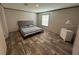 Bright bedroom featuring wood-look floors and a comfortable bed at 7337 Desant Ln, Port Charlotte, FL 33981