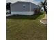 Charming home featuring gray siding, elevated design, and a well-manicured lawn at 7337 Desant Ln, Port Charlotte, FL 33981