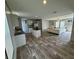 Open concept kitchen and living area with wood-look floors at 7337 Desant Ln, Port Charlotte, FL 33981