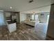 Open concept kitchen and living area with wood-look floors at 7337 Desant Ln, Port Charlotte, FL 33981