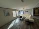 Spacious living area with large sectional sofa and wood-look floors at 7337 Desant Ln, Port Charlotte, FL 33981