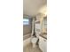 Clean bathroom with tub shower, toilet and vanity at 9116 Chantilly Ln, Port Richey, FL 34668