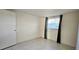 Simple bedroom with tile floors and window coverings at 9116 Chantilly Ln, Port Richey, FL 34668