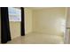 Simple bedroom with tile floors and a window at 9116 Chantilly Ln, Port Richey, FL 34668