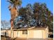 Tan house with attached garage, and large oak tree in front yard at 9116 Chantilly Ln, Port Richey, FL 34668