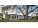 Charming house with large tree and sunroom at 9116 Chantilly Ln, Port Richey, FL 34668