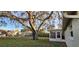 Back of house, large tree, playset visible at 9116 Chantilly Ln, Port Richey, FL 34668