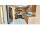 Kitchen with stainless steel appliances and wood cabinets at 9116 Chantilly Ln, Port Richey, FL 34668