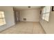 Bright living room with tile floors and large window at 9116 Chantilly Ln, Port Richey, FL 34668