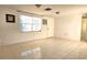 Bright living room with tile floors and large window at 9116 Chantilly Ln, Port Richey, FL 34668