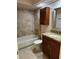Updated bathroom with tub, shower, granite vanity, and tile flooring at 9760 Lake Seminole E Dr, Largo, FL 33773