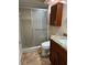 Clean bathroom with shower, toilet, vanity, and tile flooring at 9760 Lake Seminole E Dr, Largo, FL 33773