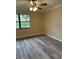 Bright bedroom with ceiling fan and wood-look flooring at 9760 Lake Seminole E Dr, Largo, FL 33773