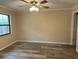 Bright bedroom with ceiling fan and wood-look flooring at 9760 Lake Seminole E Dr, Largo, FL 33773
