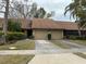 Attractive exterior of a two-unit condo building with a well-maintained landscape at 9760 Lake Seminole E Dr, Largo, FL 33773