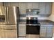 Modern kitchen with stainless steel appliances and granite countertops at 9760 Lake Seminole E Dr, Largo, FL 33773