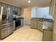 Updated kitchen featuring stainless steel appliances and granite countertops at 9760 Lake Seminole E Dr, Largo, FL 33773