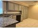 Modern kitchen with stainless steel appliances and granite countertops at 9760 Lake Seminole E Dr, Largo, FL 33773