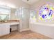 Bathroom with a shower, tub, and stained-glass window at 23635 Oakside Blvd, Lutz, FL 33559