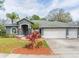 Gray house with two-car garage and landscaped front yard at 23635 Oakside Blvd, Lutz, FL 33559