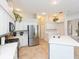 Updated kitchen with stainless steel appliances and white cabinetry at 23635 Oakside Blvd, Lutz, FL 33559