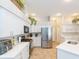 Bright kitchen featuring stainless steel appliances and white cabinetry at 23635 Oakside Blvd, Lutz, FL 33559