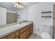 Clean bathroom with wood vanity, large mirror, and shower/tub combo at 11201 122Nd Ave # 204, Largo, FL 33778
