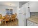 Dining area with wood table and chairs, and adjacent kitchen at 11201 122Nd Ave # 204, Largo, FL 33778
