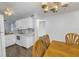 White kitchen with wood flooring, and a dining area at 11201 122Nd Ave # 204, Largo, FL 33778