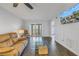Living room with a mounted TV and access to a balcony at 11201 122Nd Ave # 204, Largo, FL 33778