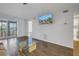 Living room with balcony access and a mounted TV at 11201 122Nd Ave # 204, Largo, FL 33778