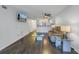 Bright living room features dark laminate floors and a view into the kitchen at 11201 122Nd Ave # 204, Largo, FL 33778