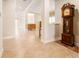 Bright and spacious entryway with tile floors and antique grandfather clock at 13905 Goldfinch Glade Ln, Lithia, FL 33547