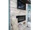 Outdoor fireplace with TV and stone facade at 16108 5Th E St, Redington Beach, FL 33708
