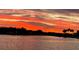 Stunning sunset over calm waters with palm trees in the foreground at 2 Brightwaters Ne Cir, St Petersburg, FL 33704