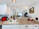 Modern kitchen with breakfast bar, white cabinets, and granite countertops at 2058 Sheffield Ct, Oldsmar, FL 34677