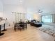 Open concept living and dining area with light hardwood floors at 2058 Sheffield Ct, Oldsmar, FL 34677