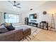 Spacious living area featuring a sectional sofa, large TV, and ample natural light at 2058 Sheffield Ct, Oldsmar, FL 34677