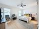 Bright bedroom with king bed, ceiling fan, and plenty of natural light at 2058 Sheffield Ct, Oldsmar, FL 34677