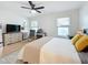 Spacious bedroom with king bed, two windows, and a ceiling fan at 2058 Sheffield Ct, Oldsmar, FL 34677