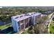 Condo building with water views and surrounding landscape at 220 Belleview Blvd # 609, Belleair, FL 33756